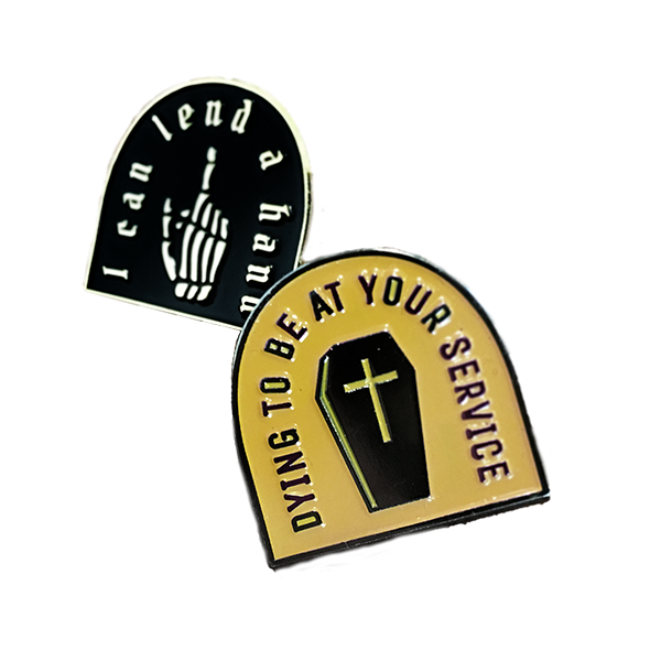 enamel pin
  with the text 'dying to be of service' and image of casket colored gold on
  silver metal